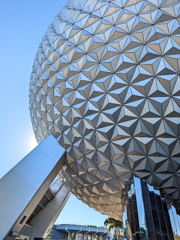 Blue skies above a close up shot of Spaceship Earth at Epcot