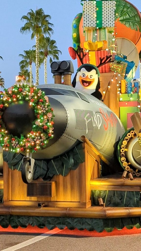 A penguin waves from one of the Madagascar themed floats during Universal's Holiday Parade featuring Macy's