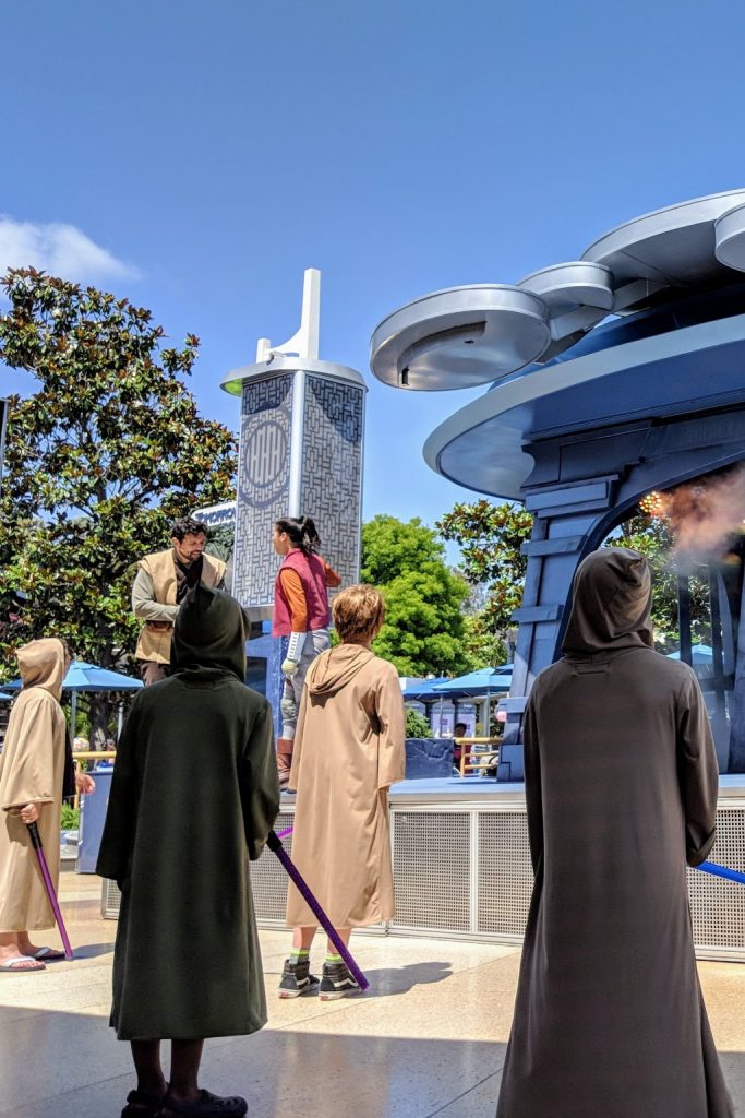 Disneyland Jedi Training is a live show where Star Wars fans can become a Jedi. Find out how to register and tips to prep your kids to fight the Dark Side. #disneyland #starwars #jeditraining