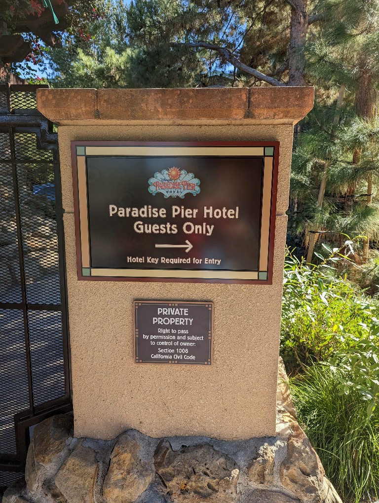 A sign shows where to enter a dedicated walkway into Disney California Adventure for Paradise Pier hotel guests