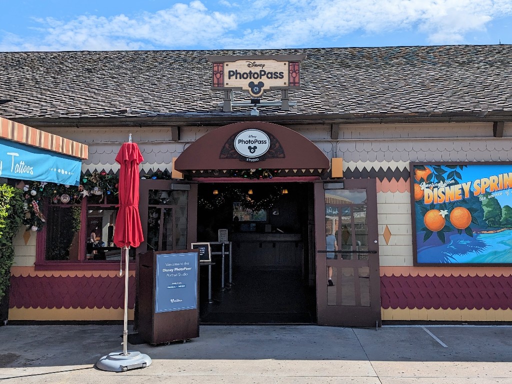 A small non-descript sign over an awning states "Disney PhotoPass Studio"