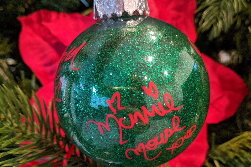 Disney character autographs are a great way to interact with characters. This DIY Disney autograph ornament makes a great souvenir and keepsake. #disneyland #disneyworld #disneycrafts #disneycharacters #disney #christmas