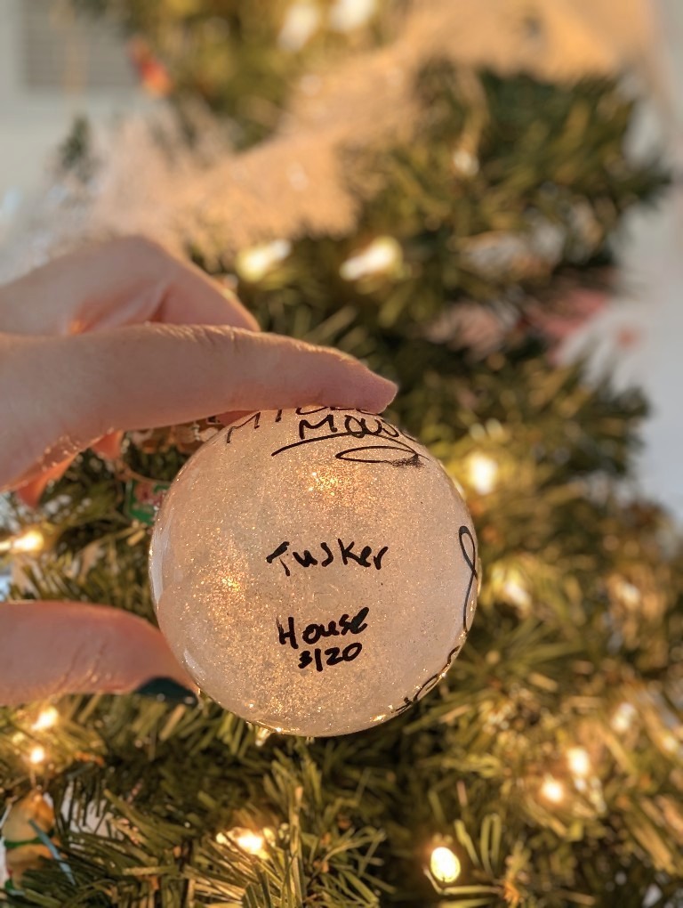 Handwritten date and location on the bottom of a glittery Disney autograph ornament