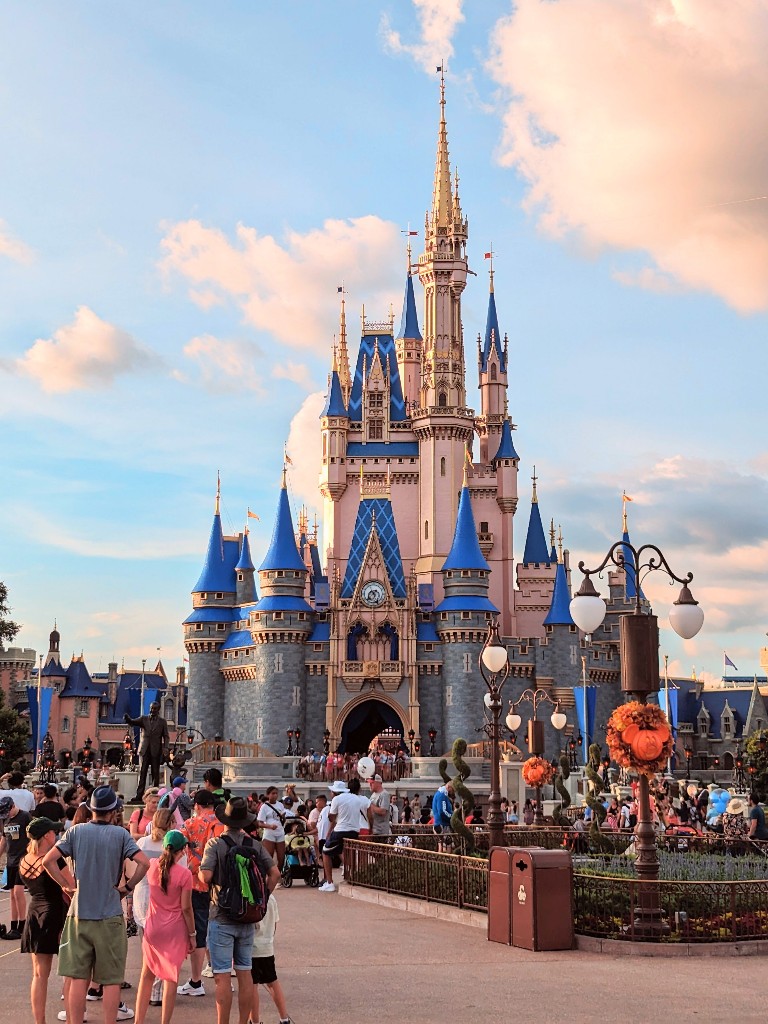 A crowd of people in front of Cinderella Castle at Disney World