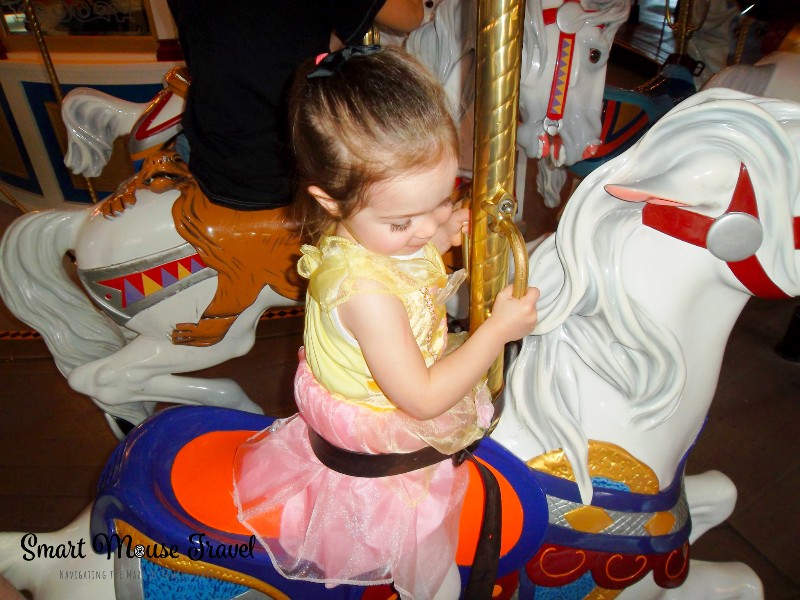 Toddler riding Prince Charming Regal Carrousel at Magic Kingdom.