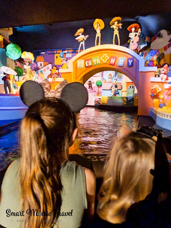 Two children riding Gran Fiesta Tour at Epcot.