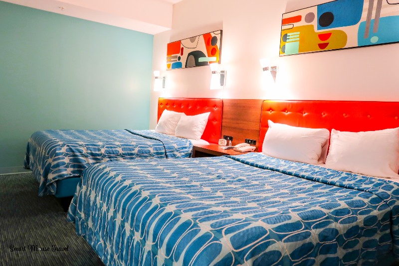 Cabana Bay Beach Resort family suite beds with orange headboards and retro art.