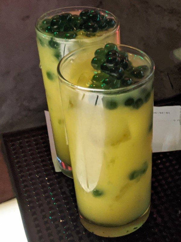 Jabba juice is a bright and refreshing mix of orange juice and other flavors topped with blue popping pearls at Oga's Cantina