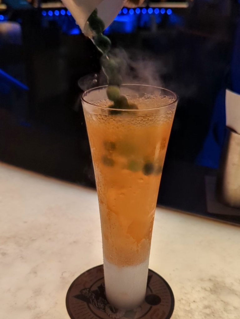 Carbon Freeze poured into a fluted glass with dry ice at Oga's Cantina
