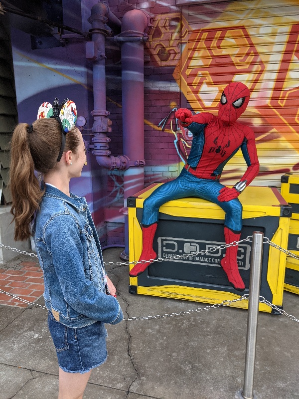 Girl chats with Spider-Man in Avengers Campus.