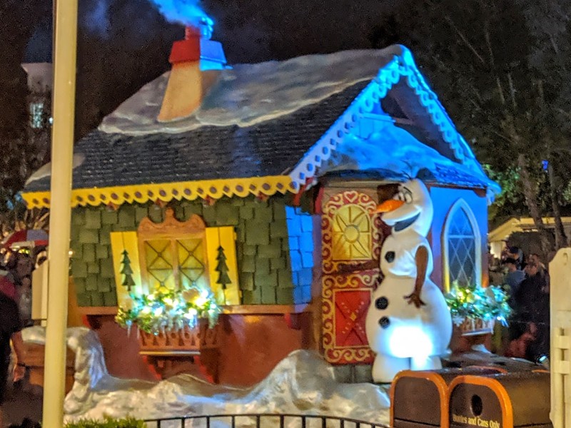 Olaf stands on a float during Mickey's Once Upon a Christmastime Parade