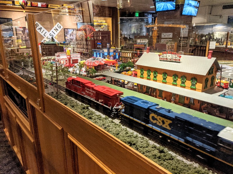 Mini trains take tracks through an impressive town display at San Diego Model Railroad Museum