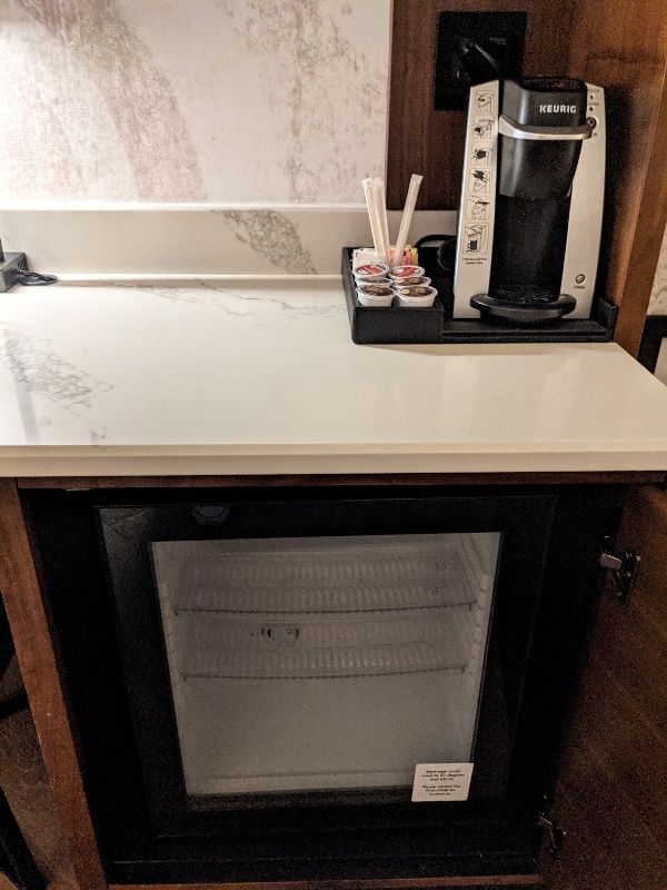 Close up of small mini fridge and Keurig coffee maker at Gran Destino Tower.