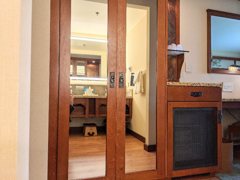 Double mirrored closet doors reflect the double vanity at Disney's Grand Californian standard room bathroom.