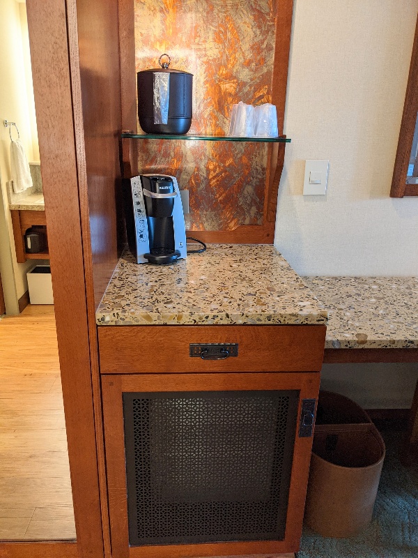 Keurig coffee pot on counter above hidden mini fridge in a Disney's Grand Californian standard room