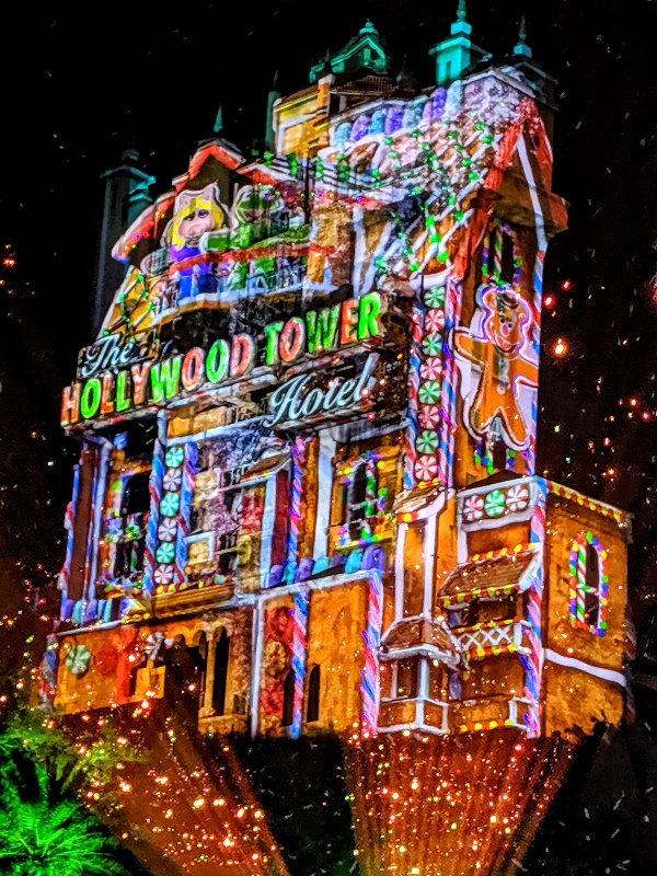 Tower of Terror with colorful festive projections that make it seem like a gingerbread house