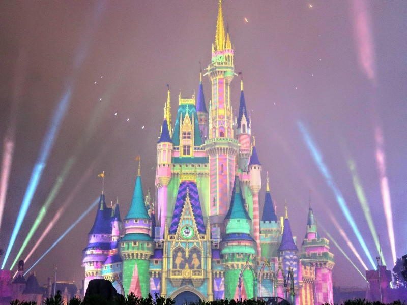 Pastel lights make Cinderella Castle look like a treat during Minnie's Wonderful Christmastime Fireworks at Magic Kingdom