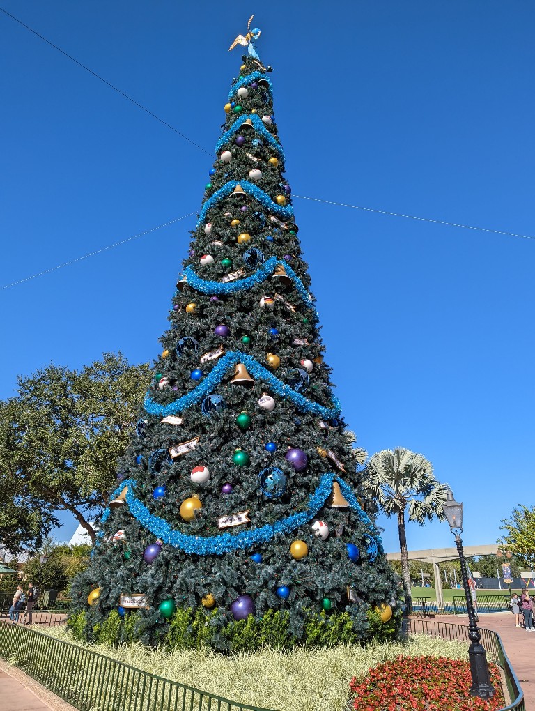 A huge Christmas tree at Epcot Festival of the Holidays has gorgeous ornaments and holiday greetings in several languages