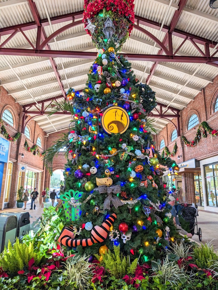 A Nightmare Before Christmas decorated tree showcases scenes and characters from this beloved movie during the Disney Springs Christmas tree stroll