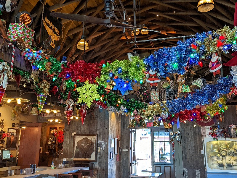 Bright tinsel, plastic Santas, and over the top holiday decorations make Jock Lindsey's Holiday Bar a perfect holiday stop at Disney Springs