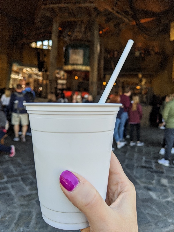 Hand holding up plastic Oga's to go cup in Galaxy's Edge