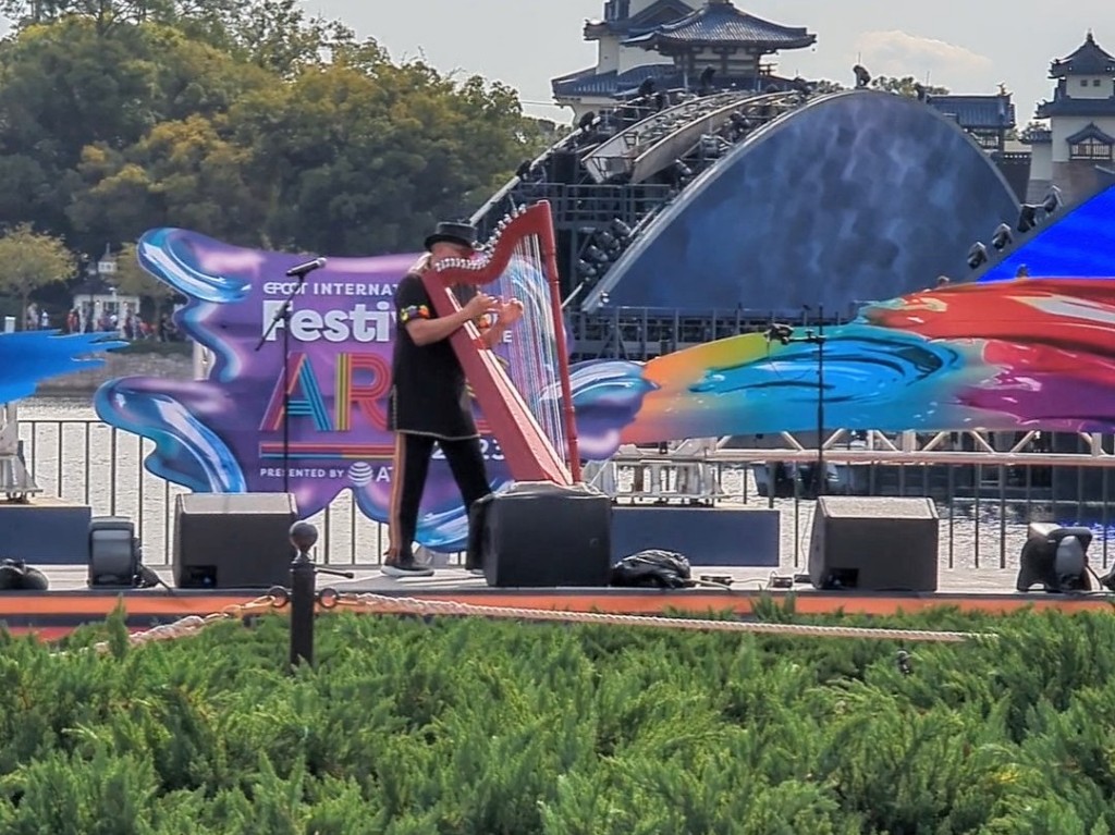 A harpist plays amazing versions of pop music at Epcot Festival of the Arts