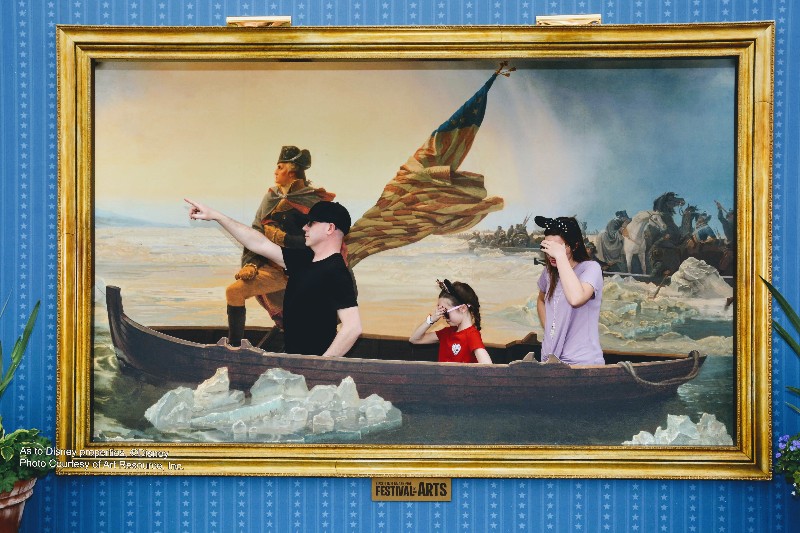 Girl and woman cover faces in embarrassment as a man pretends to lead the way in replica of George Washington Crossing the Delaware painting