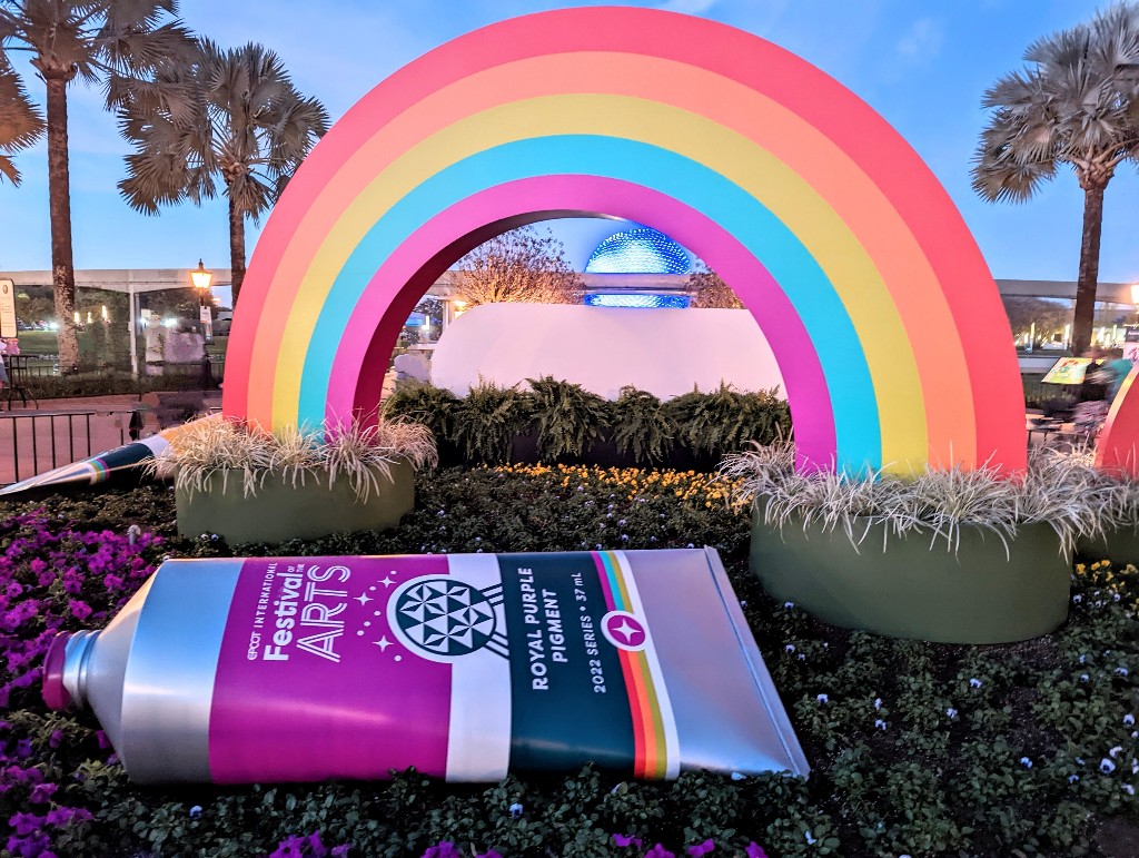 Epcot Festival of the Arts rainbow display frames Spaceship Earth in the background