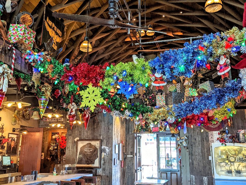 Bright tinsel stretches across Jock Lindsey's Holiday Bar at Disney Springs