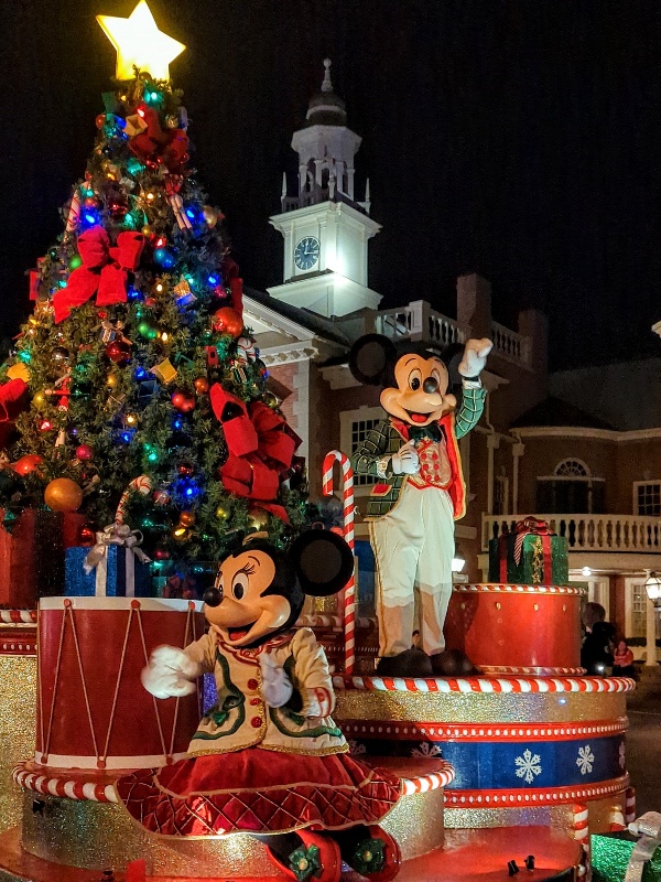 Mickey and Minnie wave to guests on a Christmas themed float at Very Merriest After Hours