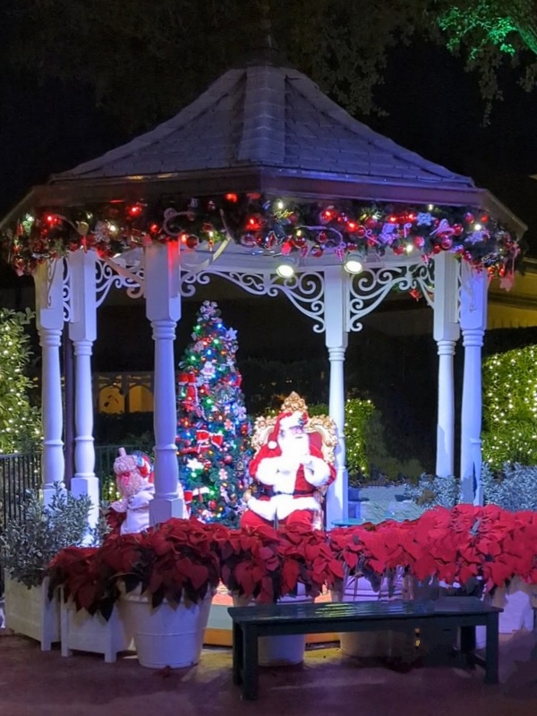 Santa waits to meet guests in a decorated gazebo in Liberty Square