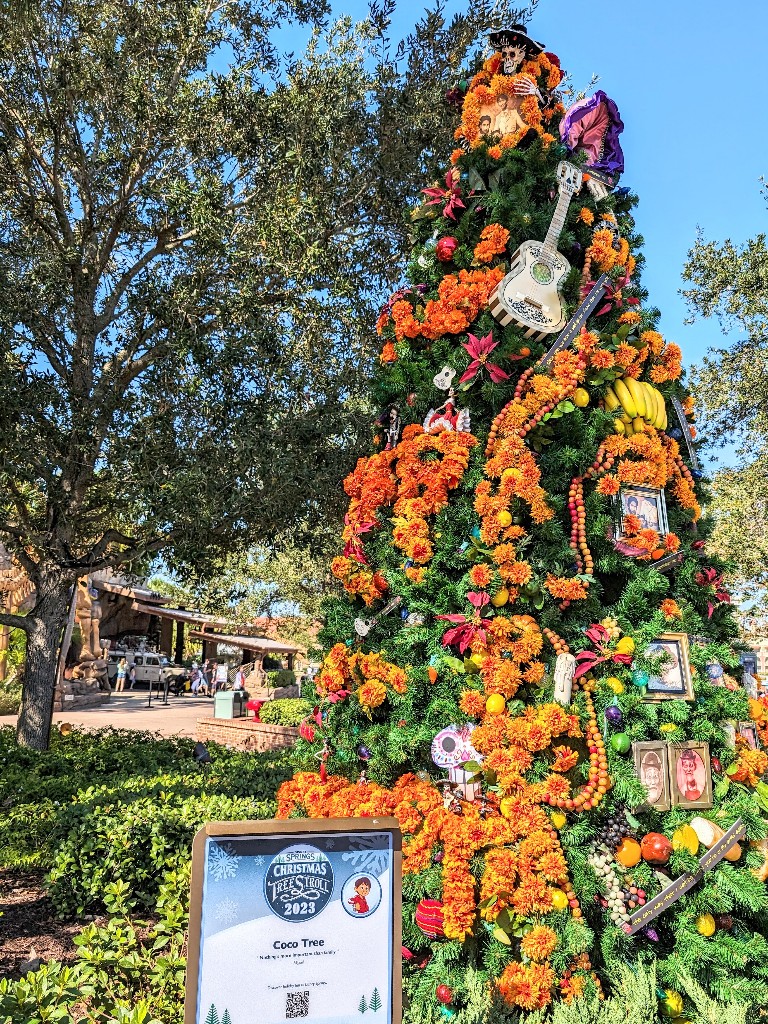 Bright yellow and orange marigolds, Miguel's guitar, and a family offrenda make the Coco tree one of the most charming and detailed on the Disney Springs Christmas Tress Stroll