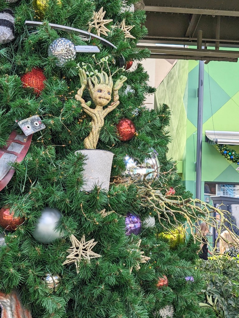 Baby Groot dances in a sparkling white planter on The Guardians of the Galaxy Christmas tree