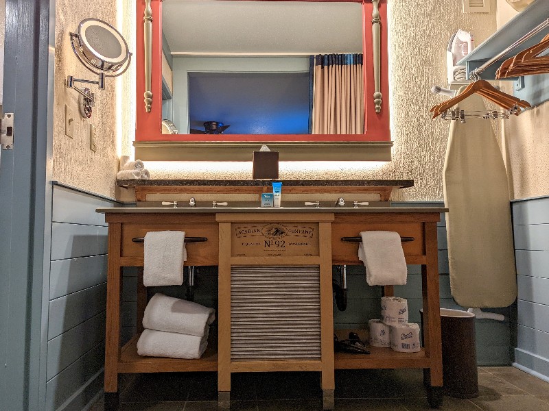 Pale blue shiplap frames the walls around Port Orleans Riverside bathroom double sinks