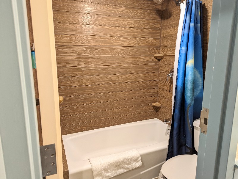 Wood grain tile around a full tub brings a rustic, but elegant look to the Port Orleans Riverside room