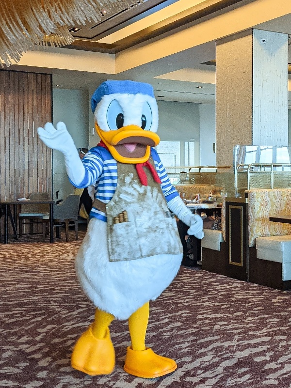 Donald Duck waves to guests dining at Topolino's Terrace