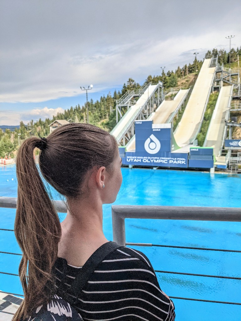 A girl waits on a balcony for the Flying Ace All Star Show at Utah Olympic Park