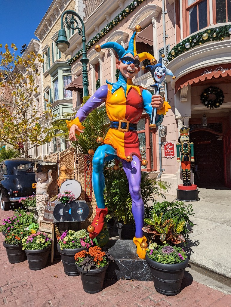 A colorful jest surrounded by plants, flowers, and records is a great Universal Mardi Gras photo op