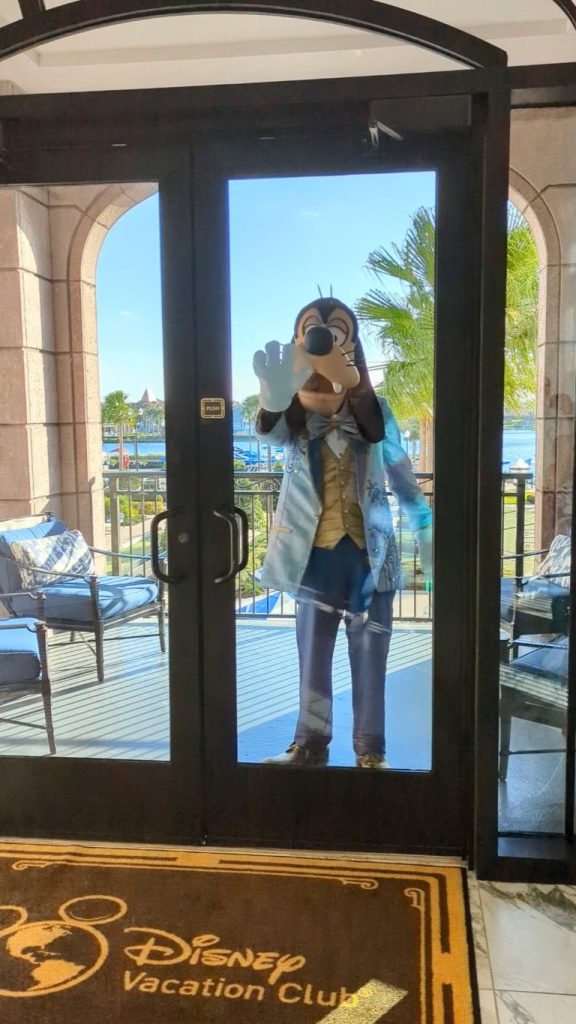 Goofy waves to guests in the Disney's Riviera Resort lobby