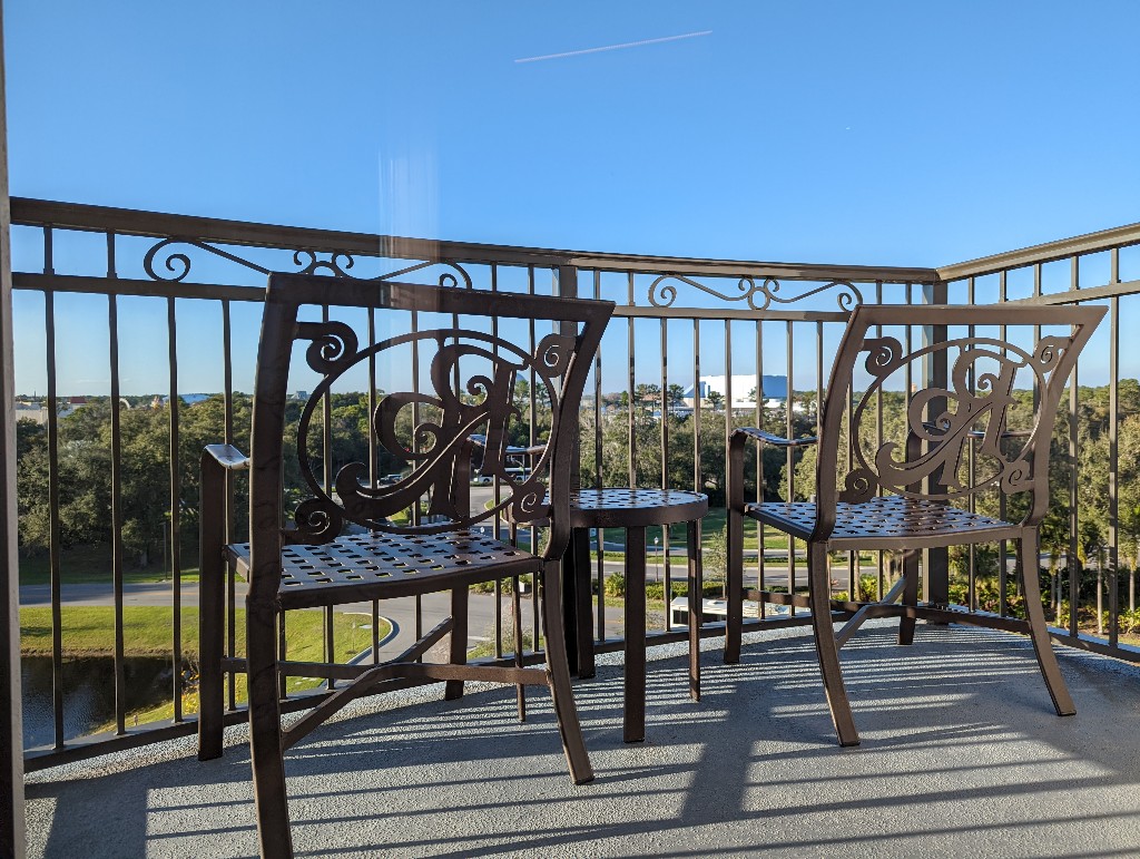 A small balcony holds two chairs in a Riviera Resort Tower Studio room