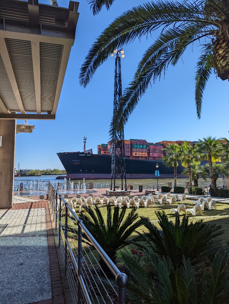 Container ships cruise by JW Marriott on their way to the Port of Savannah