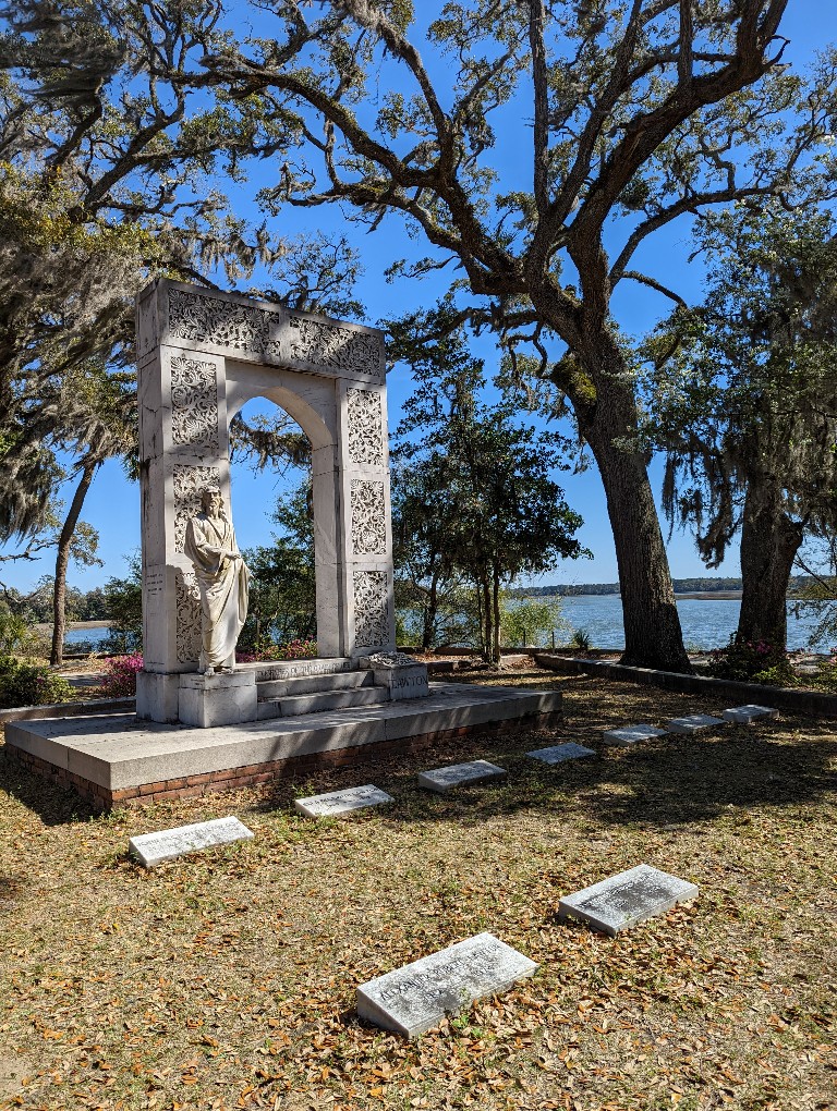 Large headstone at Bonaventure Cemetery with Wilmington River in the background