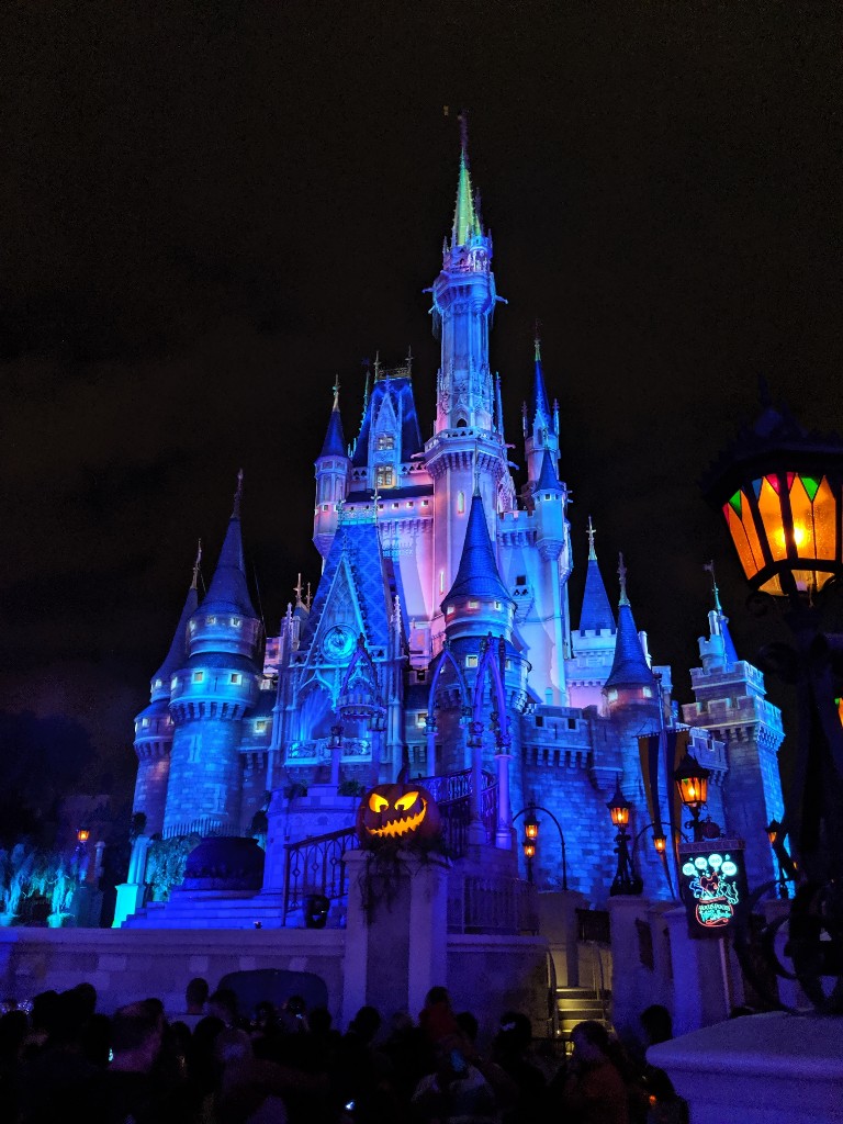 Eerily lit Cinderella Castle with flickering pumpkins