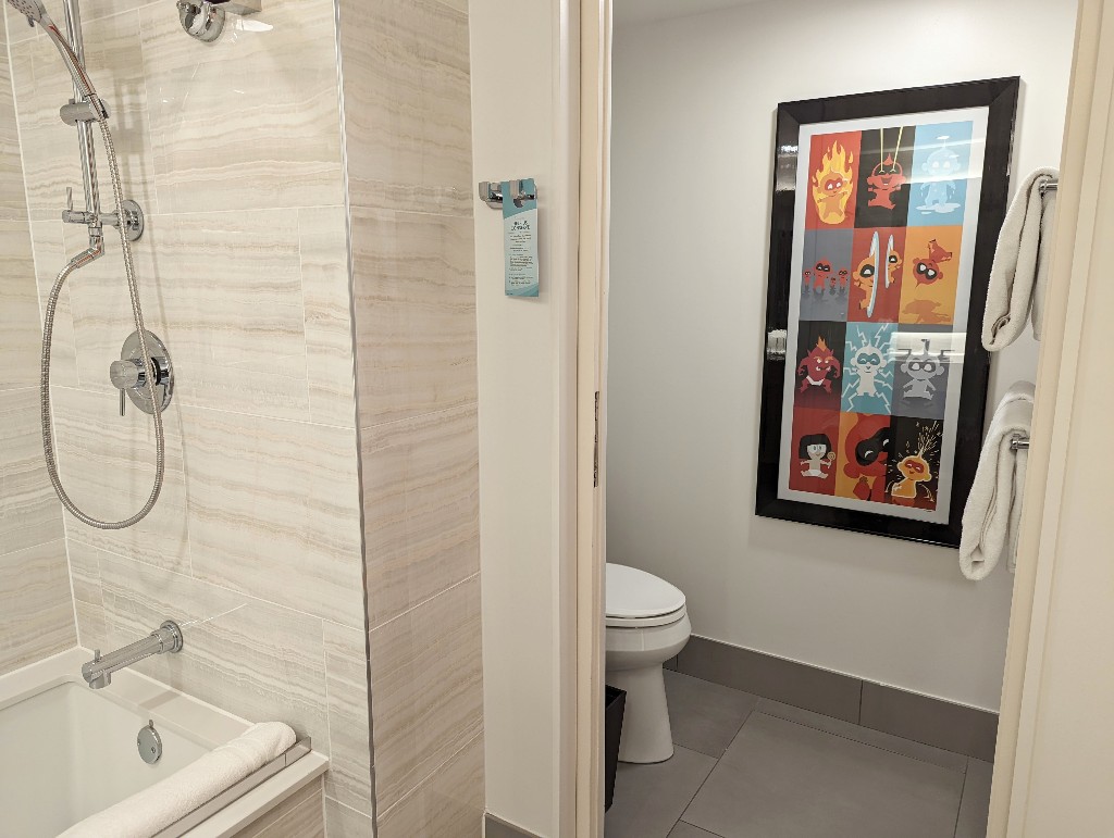 A pocket door closes off the toilet from the rest of the Contemporary Resort Main Tower bathroom