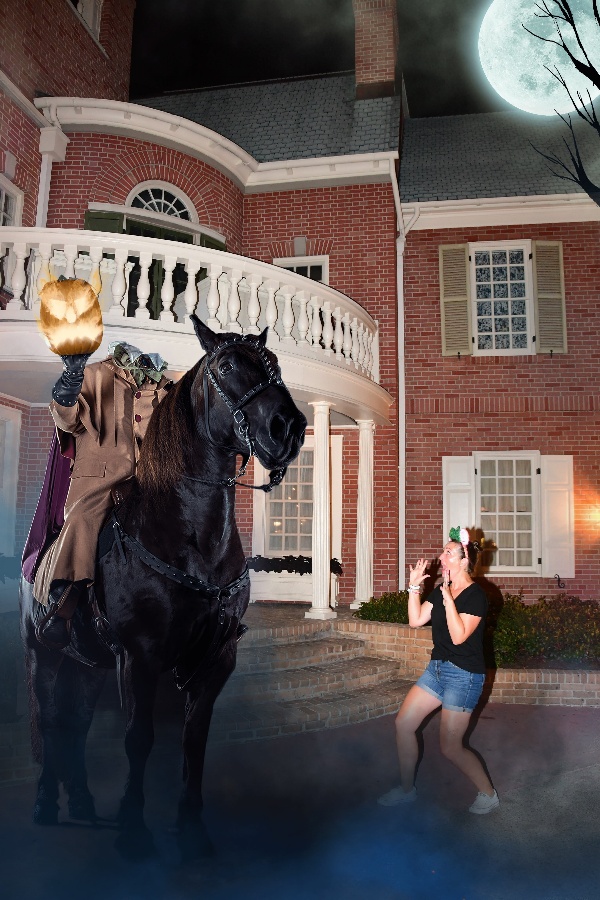 A woman looks frightened at the sight of the headless horseman