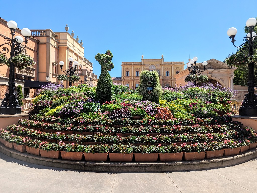 Lady and the Tramp topiaries surrounded by colorful plants in Italy during Epcot Flower and Garden Festival