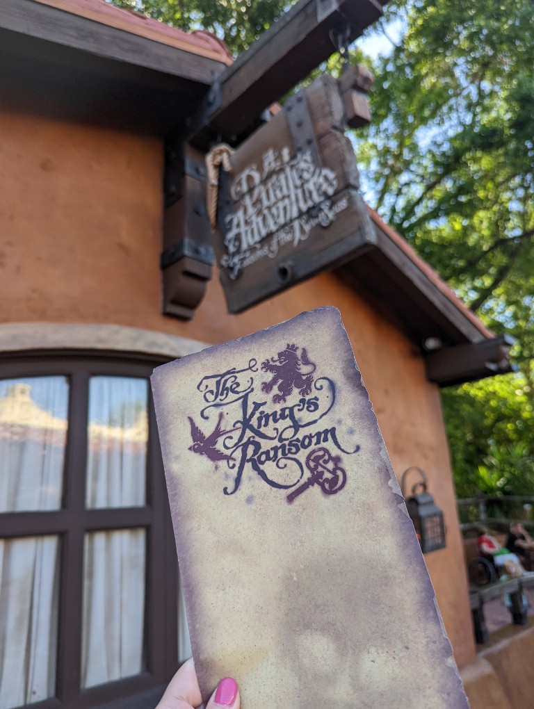 A pirate map held up in front of A Pirates Adventure enrollment center