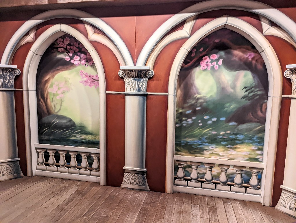 Two portrait areas at Sir Mickey's look like large windows overlooking a fairytale forest