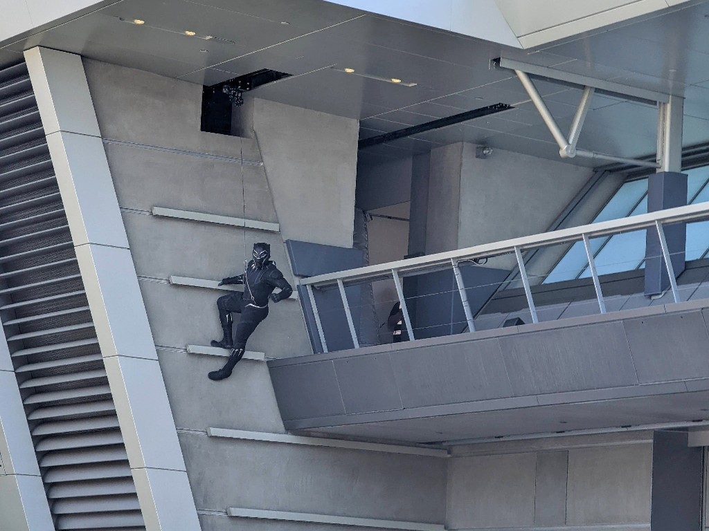 Black Panther scales a wall at Avengers Campus