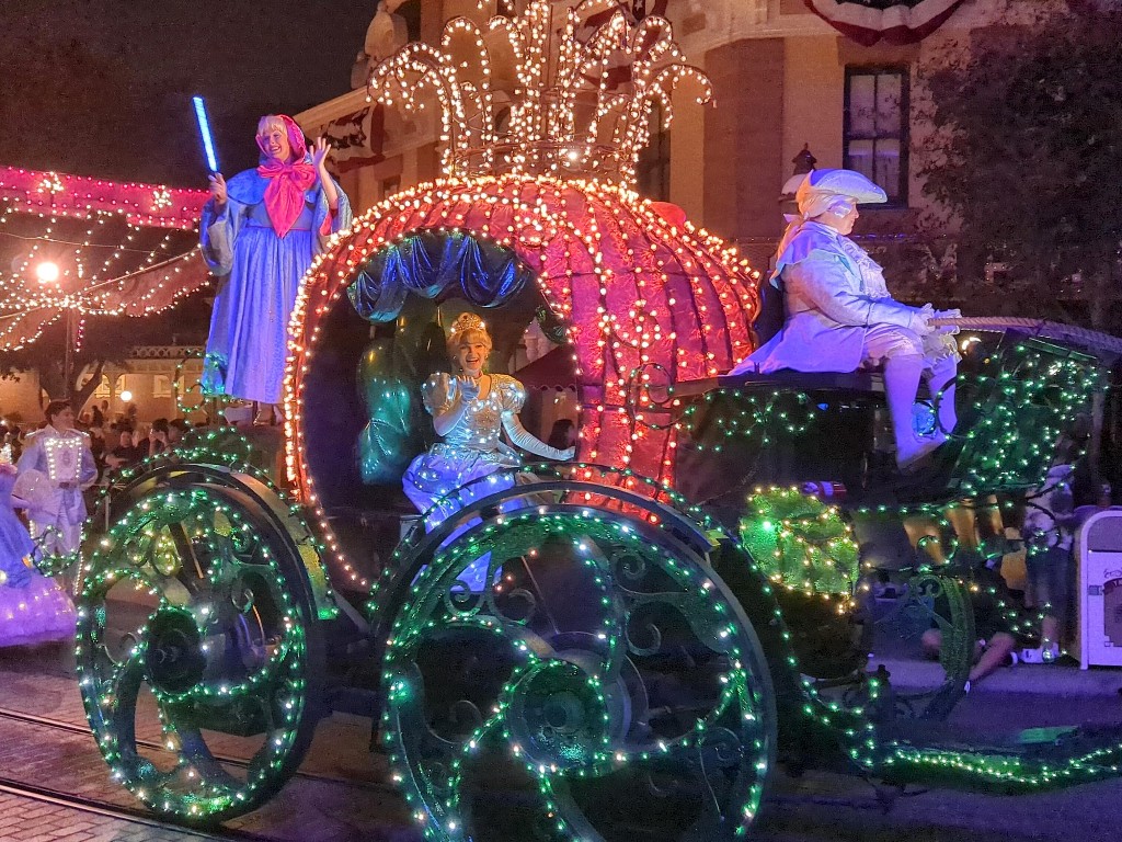 Cinderella sparkles in a light up gown and pumpkin carriage during the Main Street Electrical Parade